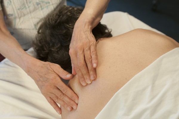 Addressing back pain through therapeutic bodywork